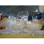 A glass bowl with swan decoration, with another bowl and two long stemmed glasses