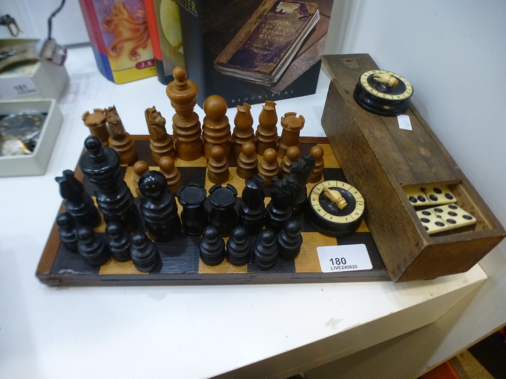 A wooden chess set and dominoes