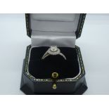 18ct White gold crossover diamond halo ring with central brilliant cut diamond ring surrounded by