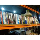 A shelf of hardback books covering mostly war related interest