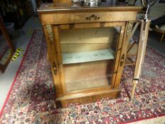 An antique walnut pier cabinet having floral inlaid decoration