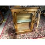 An antique walnut pier cabinet having floral inlaid decoration