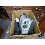 A box of mixed camera and projector equipment