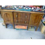 A 20th century mahogany sideboard, having two central drawers on square legs