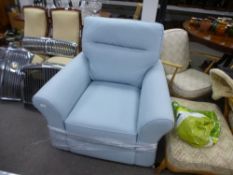 A brand new pale blue armchair by HARVEYS on pine bun feet, with original receipt