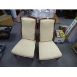 A pair of mahogany nursing chairs, having wavy back