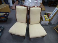 A pair of mahogany nursing chairs, having wavy back