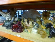 A quantity of animal figurines to include tigers, fox, otters and owls, etc