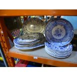 A quantity of blue and white plates and oval platters including Spode and Burleigh examples