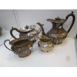 A Silver Edwardian four piece tea set, damaged, hallmarked Walker and Hall, Sheffield 1907-1914,