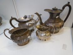 A Silver Edwardian four piece tea set, damaged, hallmarked Walker and Hall, Sheffield 1907-1914,