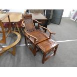 A Chinese hard wood plantation chair with pull out foot rest