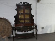 An early 20th century mahogany display cabinet, the base having two long drawers and lower shelf