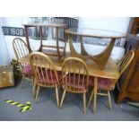 An Ercol light elm oblong dining table, 151cms and a set of our Ercol stick back chairs