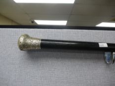 A ebony walking stick having silver knob