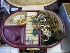 A quantity of costume jewellery contained within a burgundy Leather case