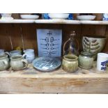 A shelf of Studio pottery and similar