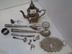 A mixed lot of white metal items including a filigree dish, tea pot, salad servers, etc., with