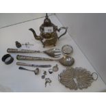 A mixed lot of white metal items including a filigree dish, tea pot, salad servers, etc., with