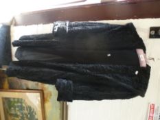 A ladies black faux fur coat