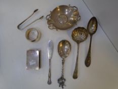 A silver lot containing spoons, tongs, napkin ring, dish, knife and matchbox cover, some marked