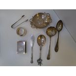 A silver lot containing spoons, tongs, napkin ring, dish, knife and matchbox cover, some marked