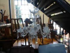 A Waterford chandelier with six branches and cut glass drops. Originally purchased in the 1990's