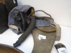 An Air Force flying hat, with rubber mask and a canvas pistol case