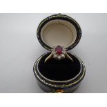 18ct yellow gold cluster ring with central ruby surrounded by small diamonds, marked 750, size L