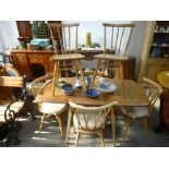 An Ercol light elm two flap kitchen table, a set of 4 Ercol Chiltern chairs and two others