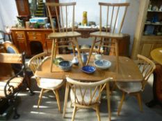 An Ercol light elm two flap kitchen table, a set of 4 Ercol Chiltern chairs and two others