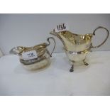 Two silver items, a silver jug and gravy boat, jug hallmarked London 1908, worn, gravy boat