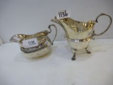 Two silver items, a silver jug and gravy boat, jug hallmarked London 1908, worn, gravy boat