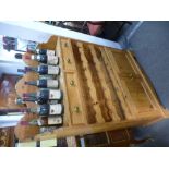 A modern pine kitchen cupboard having wine racks and two drawers