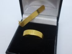 18ct yellow gold wedding band marked 18, size R, plus 18ct yellow bar brooch marked 750, total