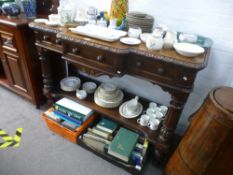 A Victorian carved oak breakfront hall table with three drawers and lower shelf, width 133cms