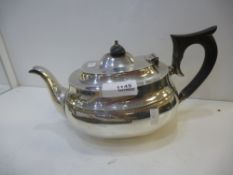 A silver teapot with a decorative border, hallmarked Sheffield 1933, Sydney Hall and Co., gross