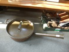 A large copper saucepan and lid