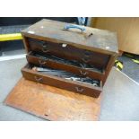 An old tool chest having five graduated drawers, containing various tools, drill bits and similar