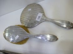 A silver dressing table brush with a matching silver hand mirror, with stripe design, hallmarked