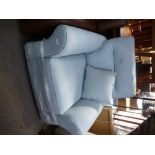 A brand new pale blue armchair by HARVEYS on pine bun feet, with original receipt