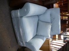 A brand new pale blue armchair by HARVEYS on pine bun feet, with original receipt