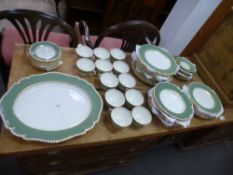 A quantity of Royal Worcester dinnerware having green border with gilt decoration
