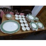 A quantity of Royal Worcester dinnerware having green border with gilt decoration