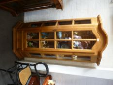 A modern pine display cabinet with one drawer