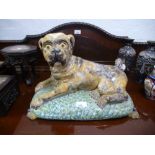 A large Staffordshire style lying pug on cushion, 43cms, probably 19th century Continental origin