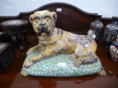 A large Staffordshire style lying pug on cushion, 43cms, probably 19th century Continental origin