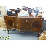 A 1920's mahogany sideboard having serpentine drawers with shaped back, width 152cms