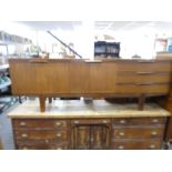 A vintage teak sideboard having three drawers, length 213 cms