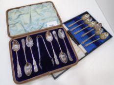 A set of Victorian decorative cased silver teaspoons with sugar tongs included, stamped Sheffield